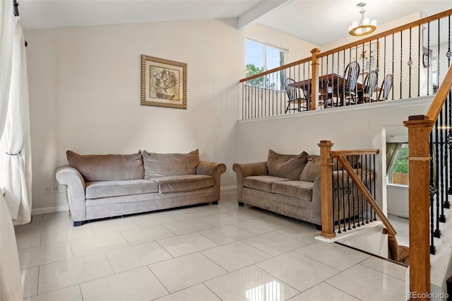 living room with vaulted ceiling with beams, light tile patterned floors, baseboards, and stairway