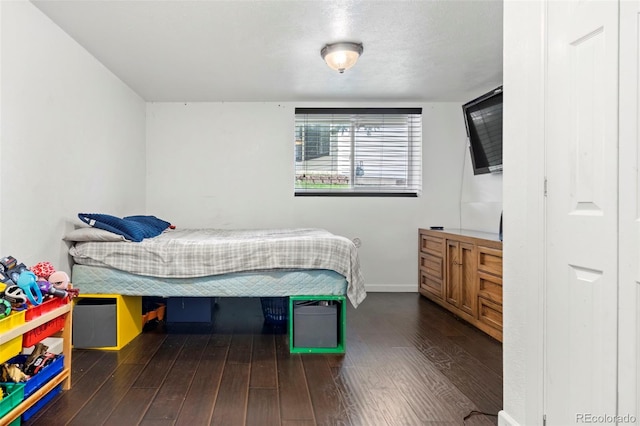 bedroom with dark wood-style floors