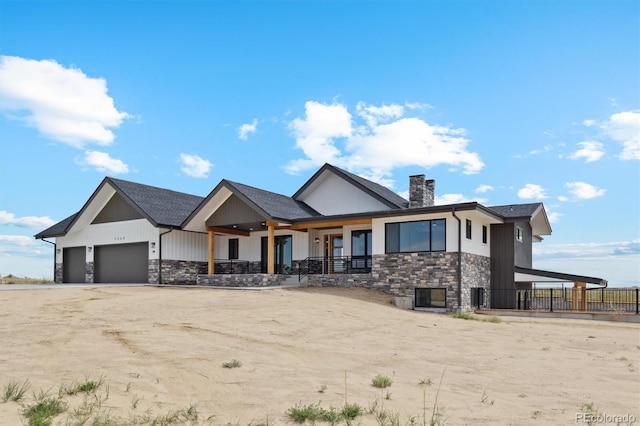 view of front of property featuring covered porch and a garage