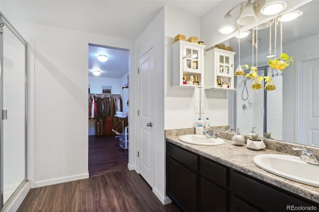 bathroom featuring a shower with door, vanity, and hardwood / wood-style floors