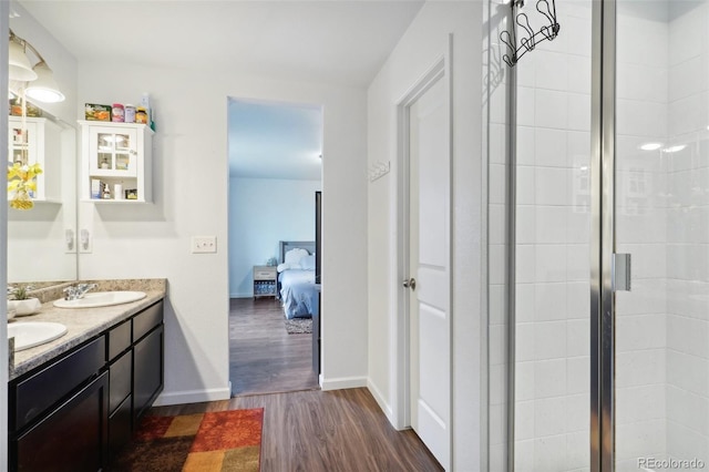 bathroom with vanity, hardwood / wood-style floors, and a shower with shower door