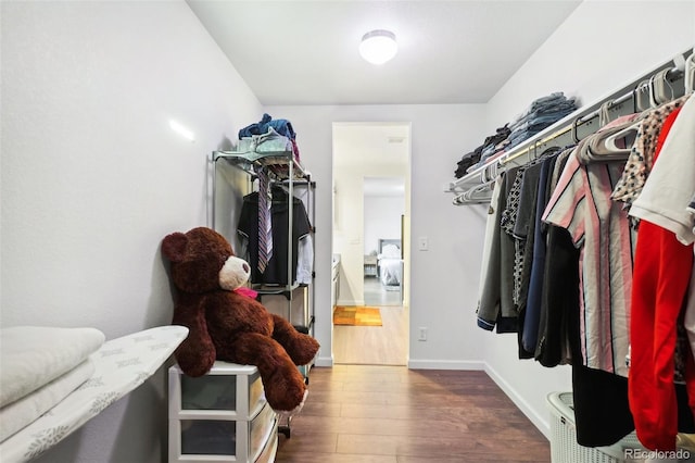 spacious closet with dark wood-type flooring