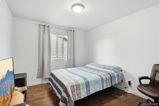 bedroom with dark hardwood / wood-style flooring