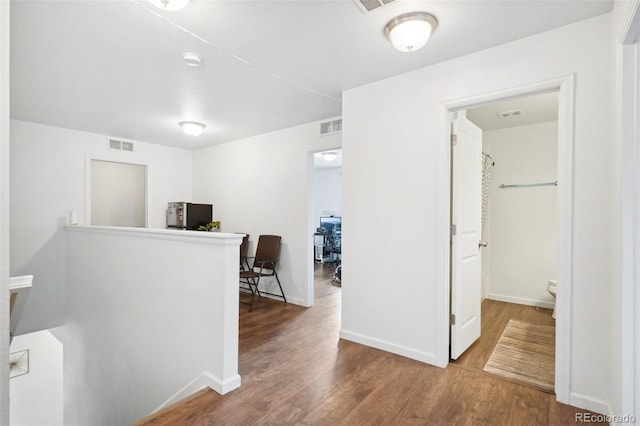 hall with wood-type flooring