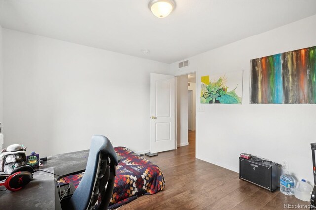 bedroom with hardwood / wood-style flooring