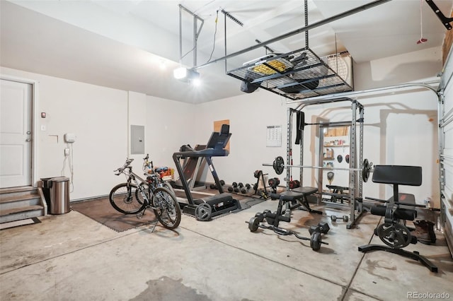 exercise room featuring electric panel and concrete floors