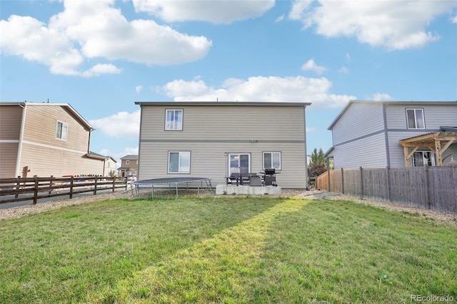 back of house featuring a yard and a patio area