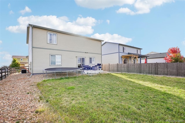 back of property with a patio and a lawn