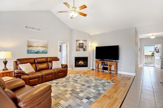 living room featuring high vaulted ceiling, light wood-type flooring, and ceiling fan