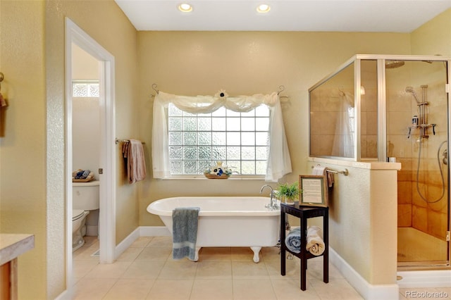 bathroom with tile patterned floors, toilet, and independent shower and bath