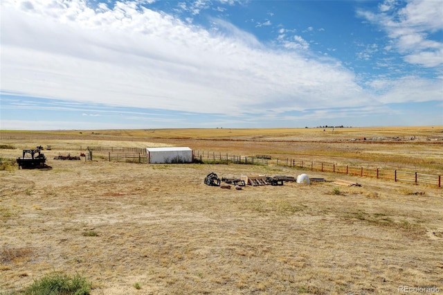 view of yard featuring an outbuilding and a rural view