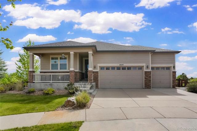 26143 E Fremont Pl, Aurora, CO 80016 - prairie-style house with an attached garage, concrete driveway, covered porch, and stone siding