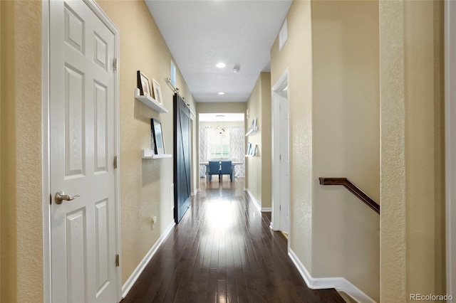 26143 E Fremont Pl, Aurora, CO 80016 - hallway with dark wood-style flooring, baseboards, and a barn door