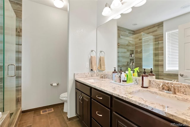26143 E Fremont Pl, Aurora, CO 80016 - bathroom with tile patterned flooring, toilet, a stall shower, double vanity, and baseboards