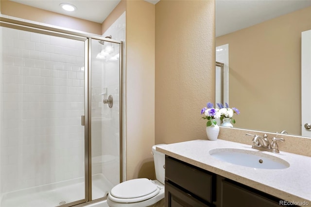 26143 E Fremont Pl, Aurora, CO 80016 - bathroom with toilet, a stall shower, a textured wall, and vanity