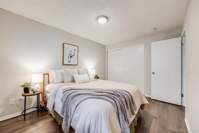 1349 Race St Unit 5, Denver, CO 80206 - bedroom featuring wood finished floors, baseboards, a textured ceiling, and a closet