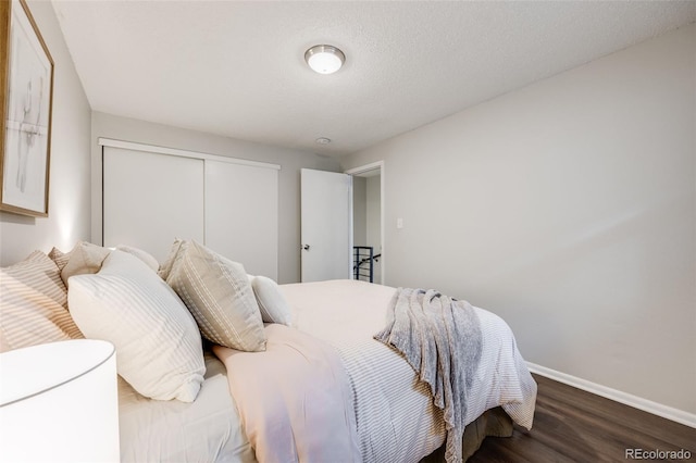 1349 Race St Unit 5, Denver, CO 80206 - bedroom featuring baseboards, wood finished floors, and a closet