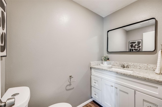 1349 Race St Unit 5, Denver, CO 80206 - half bathroom featuring vanity and wood finished floors