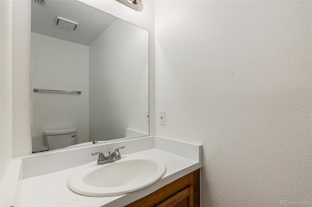 bathroom with vanity and toilet