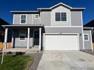 view of front of property featuring a garage, concrete driveway, and a porch