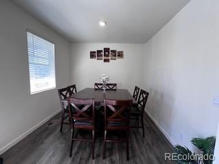 dining area featuring baseboards and wood finished floors