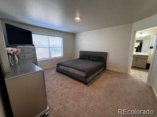 bedroom featuring carpet, connected bathroom, and baseboards