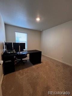 carpeted office space with baseboards