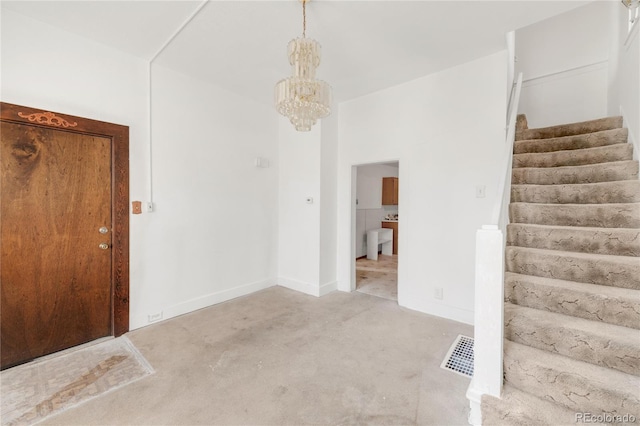 carpeted spare room with visible vents, stairway, a chandelier, and baseboards