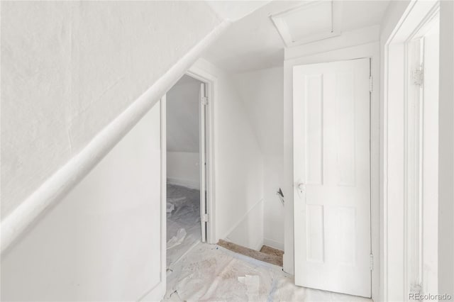 interior space featuring attic access and vaulted ceiling