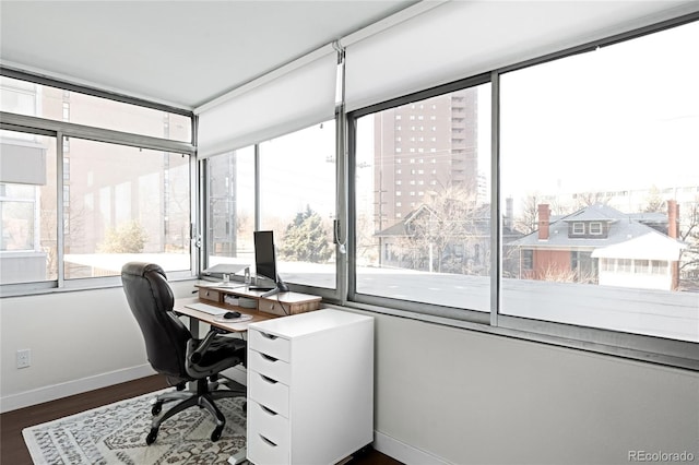 office with dark wood-style flooring and baseboards