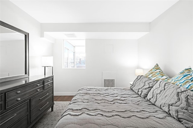 bedroom featuring dark wood-style flooring and baseboards