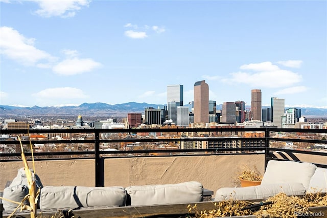 exterior space with a balcony, a mountain view, and a city view