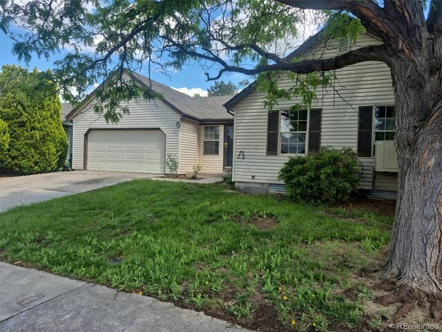16094 E Exposition Dr, Aurora, CO 80017 - view of front of house with an attached garage, concrete driveway, and a front lawn