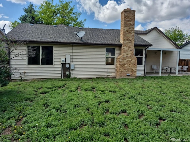 16094 E Exposition Dr, Aurora, CO 80017 - rear view of house with a patio area, a yard, a chimney, and roof with shingles