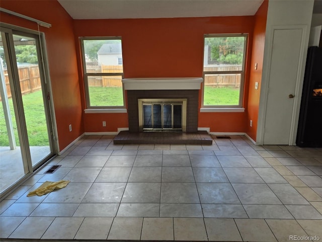 16094 E Exposition Dr, Aurora, CO 80017 - unfurnished living room with light tile patterned floors, healthy amount of natural light, and baseboards
