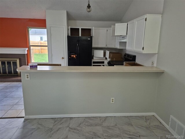 16094 E Exposition Dr, Aurora, CO 80017 - kitchen with black fridge, electric range oven, a fireplace, a peninsula, and light countertops