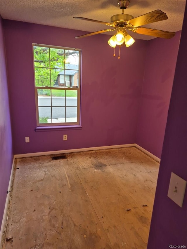 16094 E Exposition Dr, Aurora, CO 80017 - empty room with a textured ceiling, baseboards, and a ceiling fan