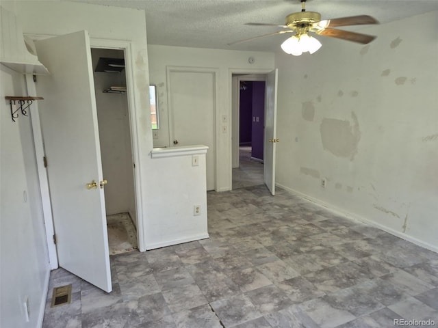 16094 E Exposition Dr, Aurora, CO 80017 - unfurnished bedroom with a textured ceiling, ceiling fan, and baseboards