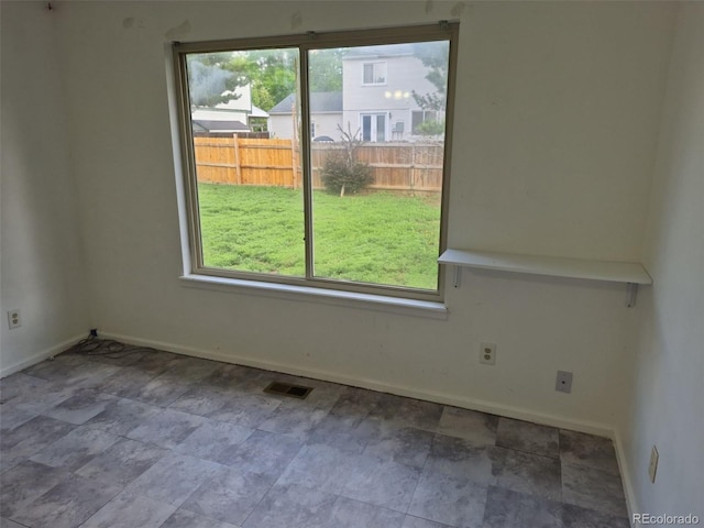 16094 E Exposition Dr, Aurora, CO 80017 - empty room with baseboards and stone finish floors