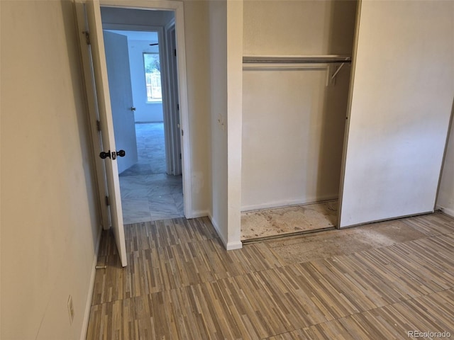 16094 E Exposition Dr, Aurora, CO 80017 - unfurnished bedroom with a closet, baseboards, and wood finished floors