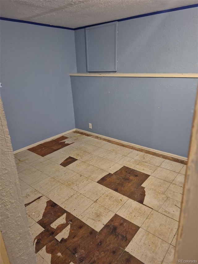 16094 E Exposition Dr, Aurora, CO 80017 - spare room with baseboards and a textured ceiling