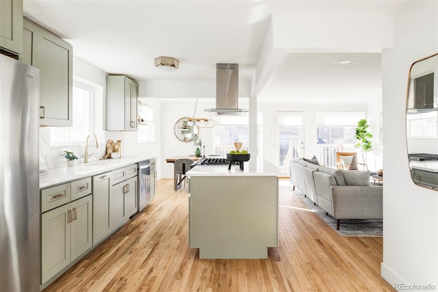 kitchen with light hardwood / wood-style floors, a center island, island exhaust hood, and stainless steel appliances