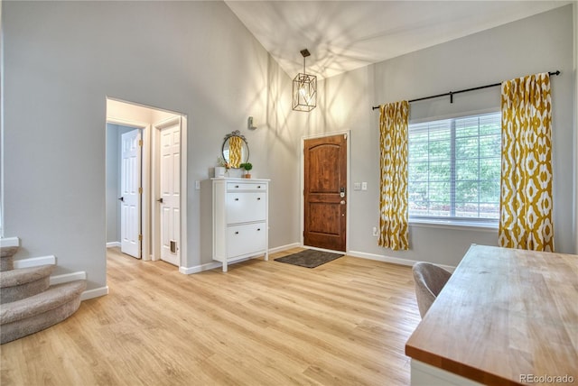 5532 S Valdai Way, Aurora, CO 80015 - entryway with a towering ceiling, light wood-type flooring, baseboards, and stairway