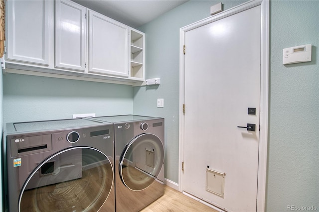 5532 S Valdai Way, Aurora, CO 80015 - laundry room with washing machine and dryer, cabinet space, light wood finished floors, and baseboards