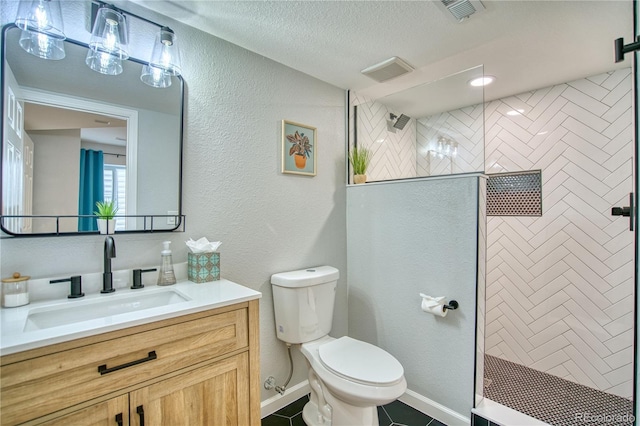 5532 S Valdai Way, Aurora, CO 80015 - full bathroom with vanity, toilet, a walk in shower, a textured ceiling, and tile patterned flooring
