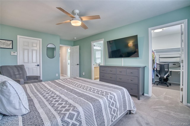 5532 S Valdai Way, Aurora, CO 80015 - bedroom featuring a walk in closet, a closet, light carpet, a ceiling fan, and ensuite bathroom