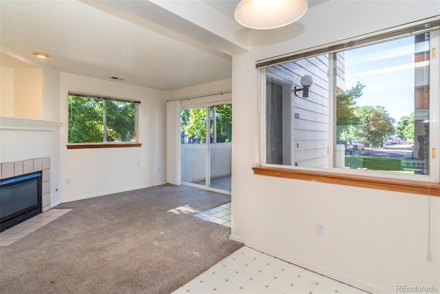 2850 Aurora Ave Unit 112, Boulder, CO 80303 - unfurnished living room with a tile fireplace, carpet, baseboards, and tile patterned floors
