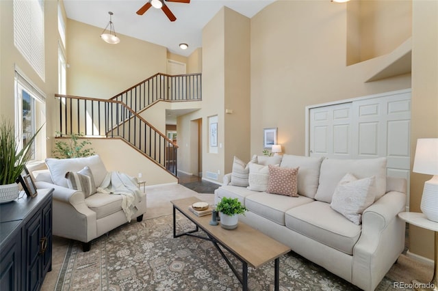 12814 Forest Cir, Thornton, CO 80241 - living room with a towering ceiling, a ceiling fan, stairway, and carpet flooring