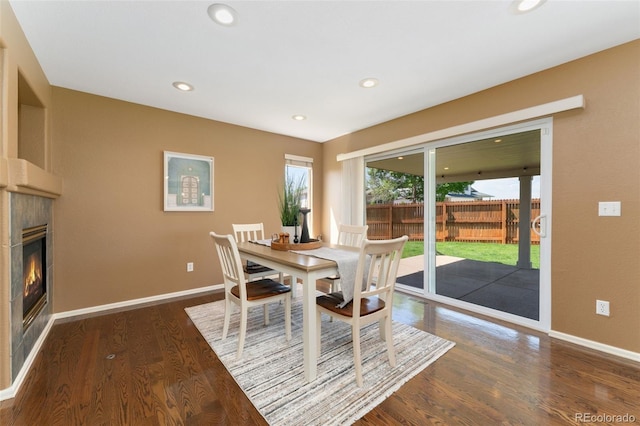 12814 Forest Cir, Thornton, CO 80241 - dining space with baseboards, recessed lighting, a glass covered fireplace, and wood finished floors