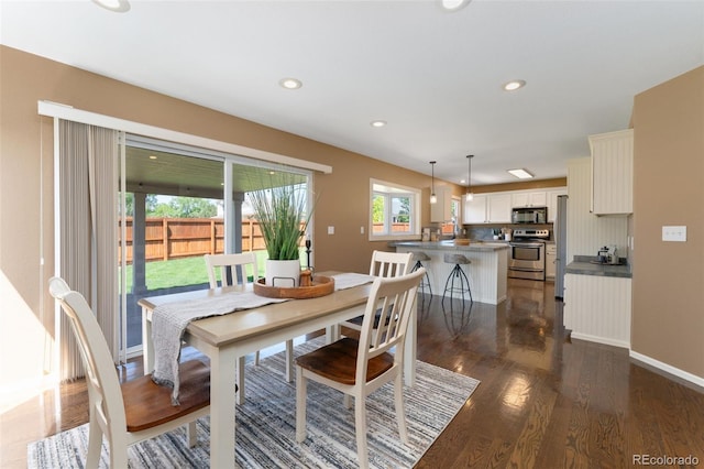 12814 Forest Cir, Thornton, CO 80241 - dining area featuring dark wood finished floors, recessed lighting, and baseboards